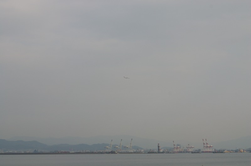An airplane in the hazy sky.
