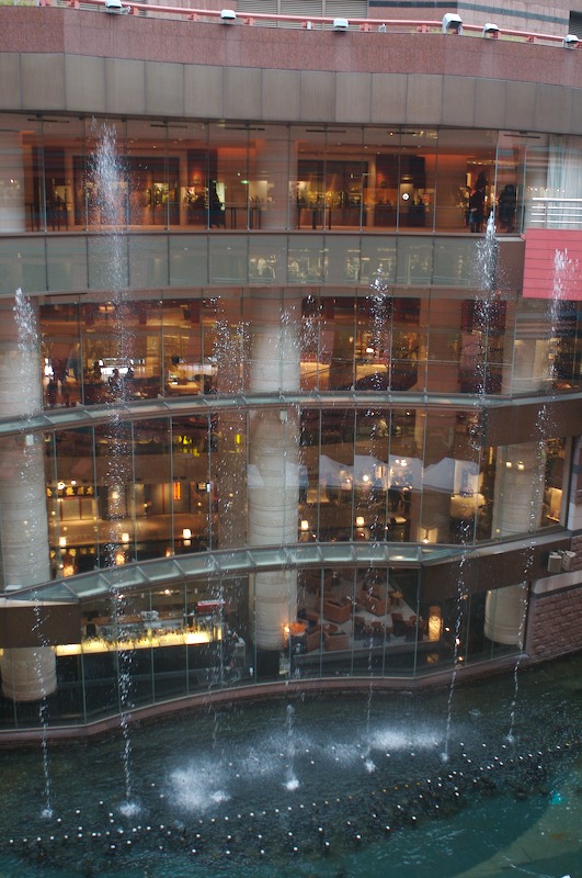 The water shoots up to near the top of the Grand Hyatt hotel across the canal from the shops.